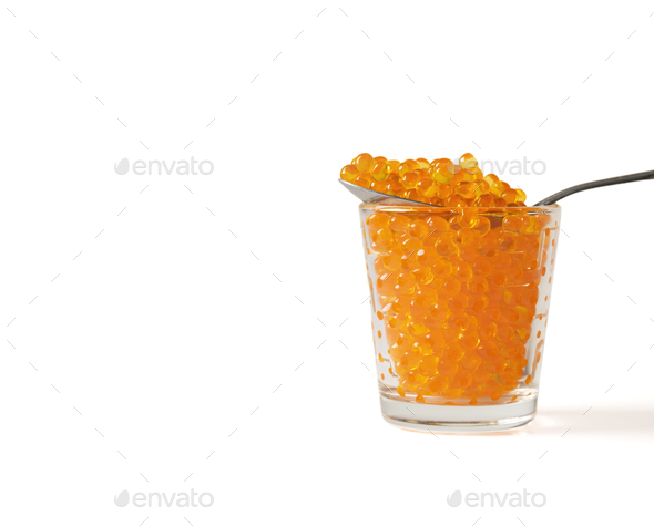 Red Caviar in the Silver Spoon over little individual Caviar jar - Stock Photo - Images