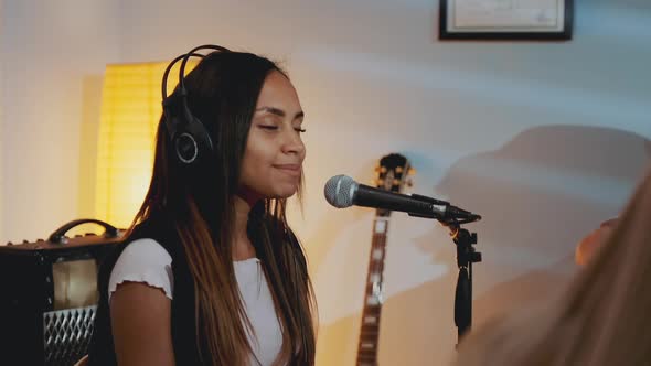 Black Girl in Headphone Singing Into Microphone at the Rehearsal in Home Studio alt