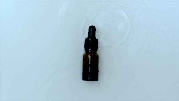 Cosmetics in a Bottle on a Water Background alt