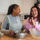 Happy African mother and daughter preparing a homemade dessert - PhotoDune Item for Sale
