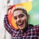 Happy gay man celebrating the pride festival with the LGBTQ rainbow flag - PhotoDune Item for Sale