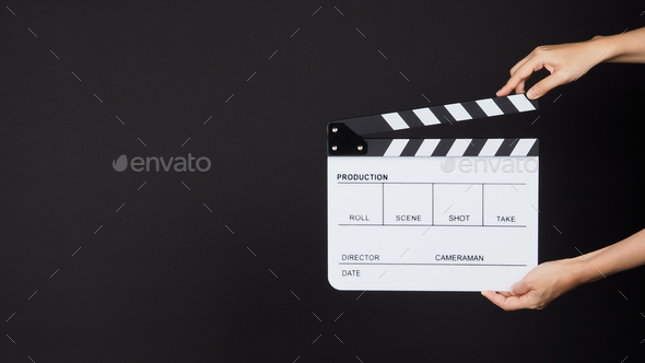 Two Hand\'s holding white Clapperboard or Clap board or movie slate use in video on black background.
