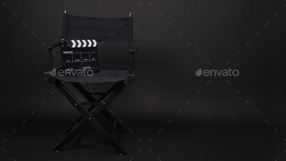 Black clap board and director chair on black background.