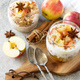 Homemade dessert with yogurt, granola, caramel apples and cinnamon on a stone table. Copy space. - PhotoDune Item for Sale