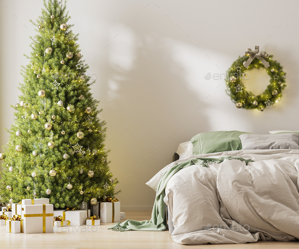 Christmas three with ornaments, festive lights and white and golden gift boxes in room near bed - Stock Photo - Images