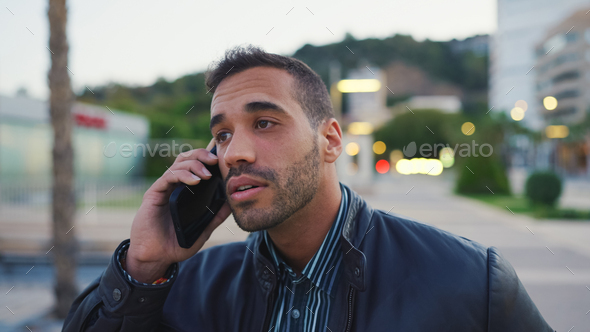 Close up young brunette man looking pensive waiting his girlfriend outdoors - Stock Photo - Images