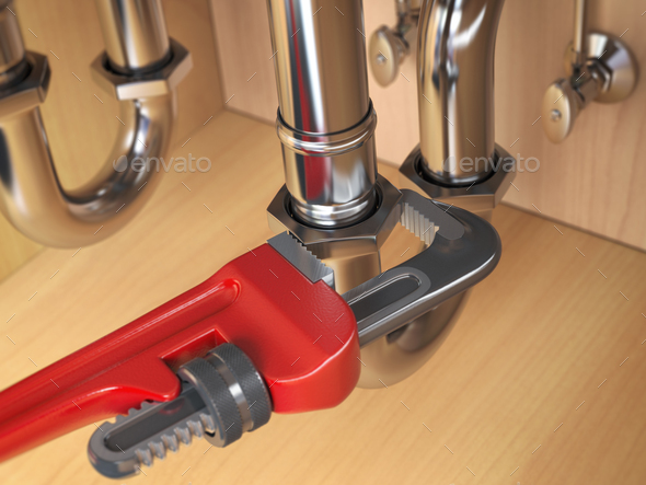 Pllumber using an ajustable wrench to repair a water pipe under the sink. - Stock Photo - Images