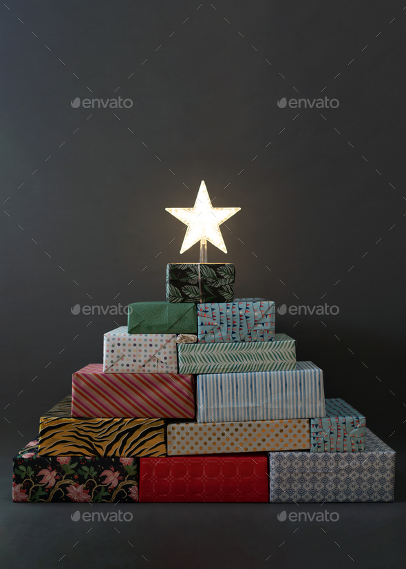 Christmas tree built from gifts with the star on top Stock Photo by