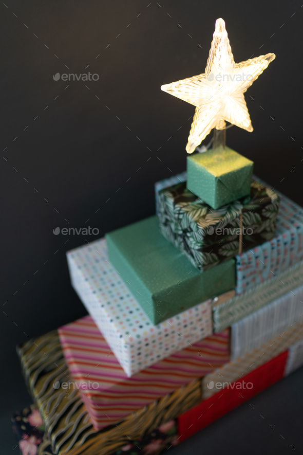 Christmas tree built from gifts with the star on top Stock Photo by
