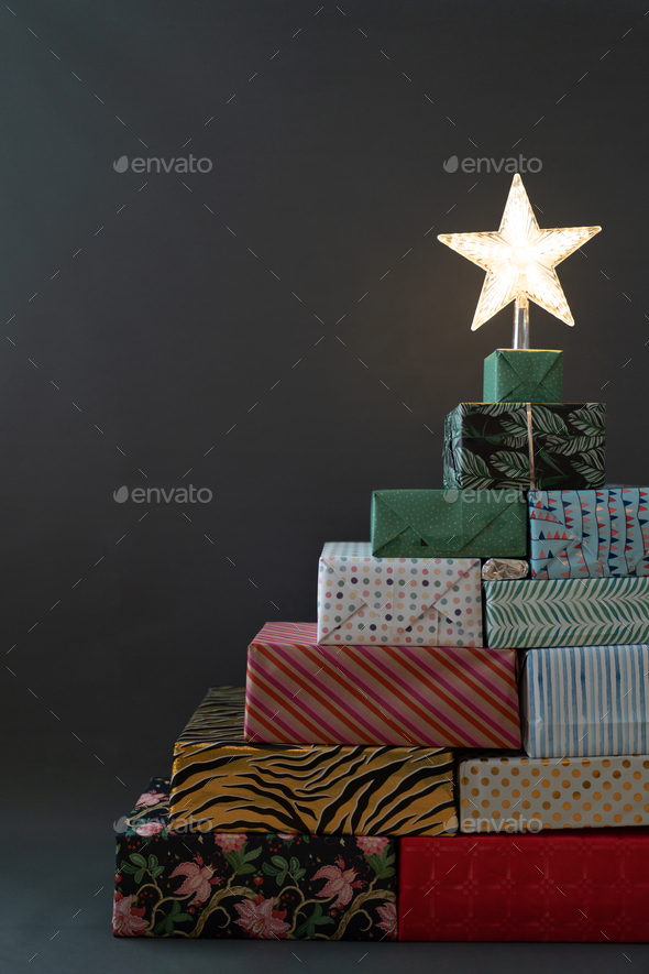 Christmas tree built from gifts with the star on top Stock Photo by