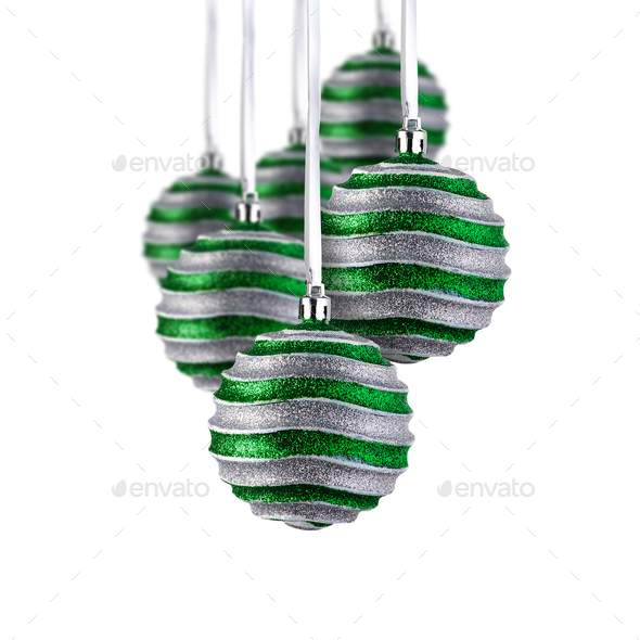 Set of green Christmas ornaments hanging over white background