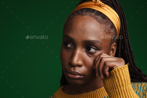 Young black woman wearing headband wiping her tears while crying Stock ...