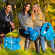 Focused team of young volunteers collecting garbage to protect the environment - PhotoDune Item for Sale