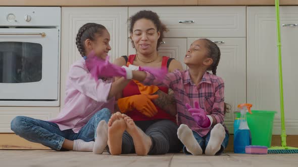 Cheerful Family Giving High Five After Cleanup alt