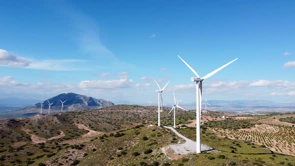 Windmills rotating in Spanish wind farm drone shot, aerial view of wind mill in Spain. alt