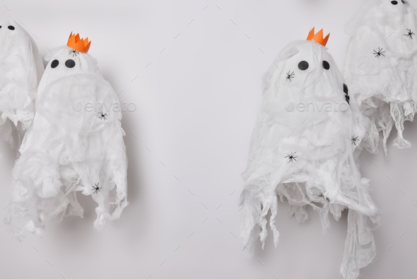 Spooky ghosts with crowns on heads and spiders isolated over grey background. Halloween party celebr - Stock Photo - Images
