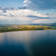 Flying drone over large lake with view of mountain peaks - PhotoDune Item for Sale