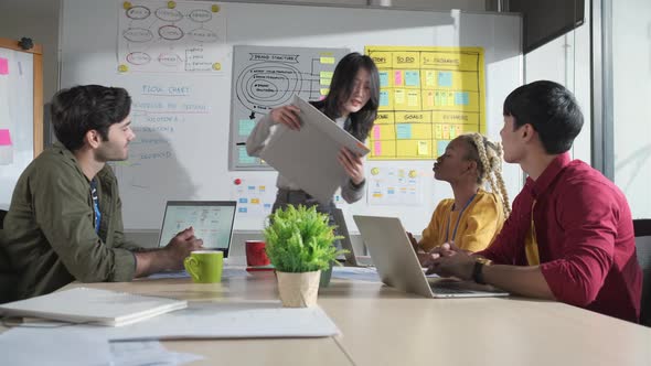 Businessman creative designers present work to the team.Designers a meeting in a modern office.