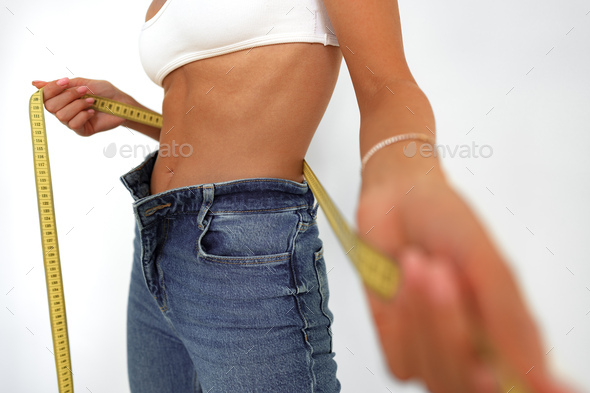 Close Up Shot Woman With Slim Body Measuring Torso Stock Photo