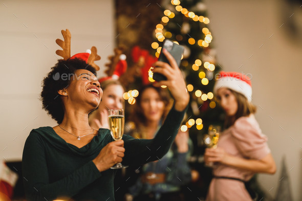 Multiracial Group Of Female Friends Making Video Call Near Christmas Tree - Stock Photo - Images