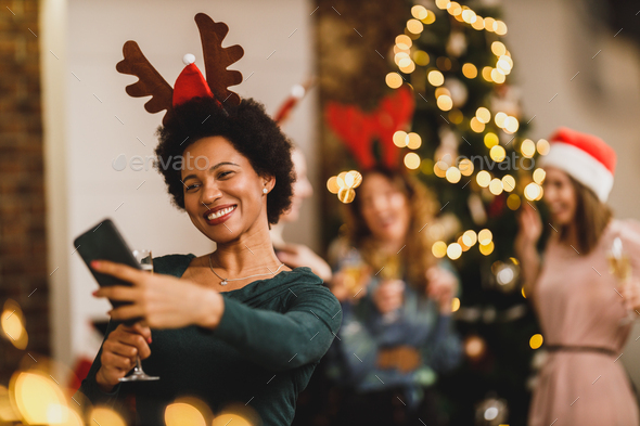 Multiracial Group Of Female Friends Taking Selfie Near Christmas Tree - Stock Photo - Images