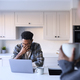 Couple At Home Working On Laptop On Counter In Kitchen - PhotoDune Item for Sale
