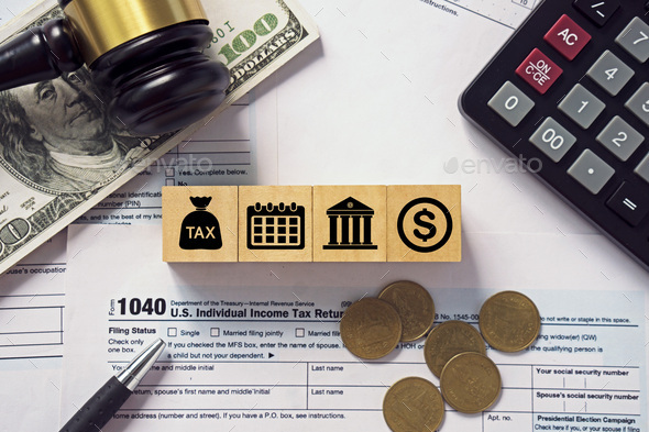 Tax concept.Tax icon on wooden block.Calculator with money on 1040 tax form.Income tax return. - Stock Photo - Images