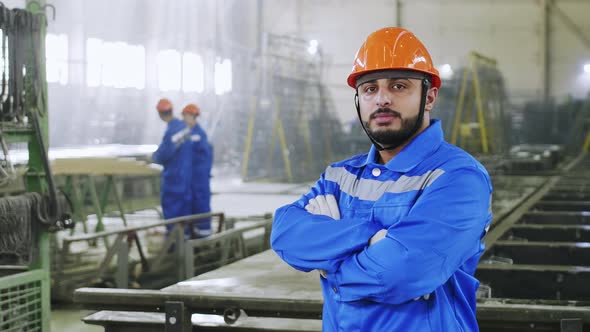 Middle Eastern factory worker staying at workplace