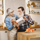 Senior couple with gifts in a kitchen - PhotoDune Item for Sale