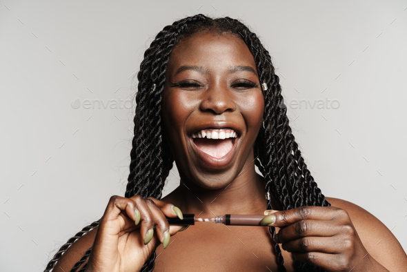 Shirtless Black Woman Laughing While Posing With Lip Gloss Stock Photo