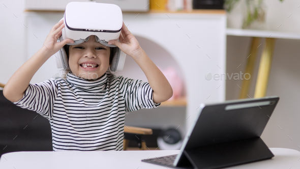 Little girl using VR glasses at home for learning Solar system planets.
