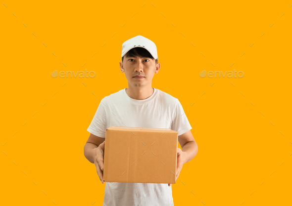 Young Asian delivery man wearing cap and white blank t-shirt holding parcel post box