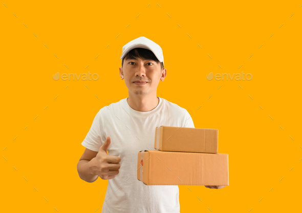 Young Asian delivery man wearing cap and white blank t-shirt holding parcel post box