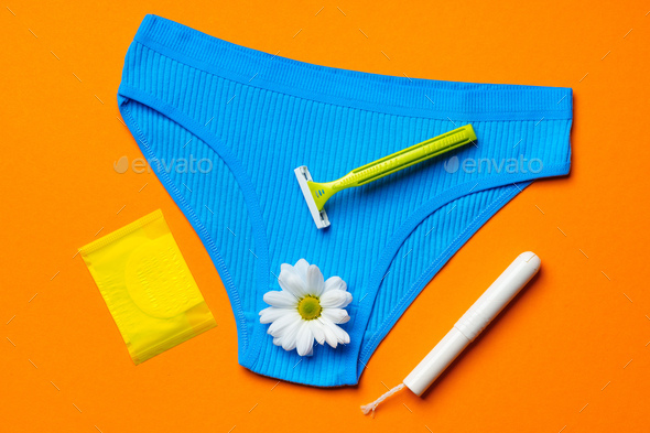 Women's panties with sanitary tampon on color background - Stock Photo - Images