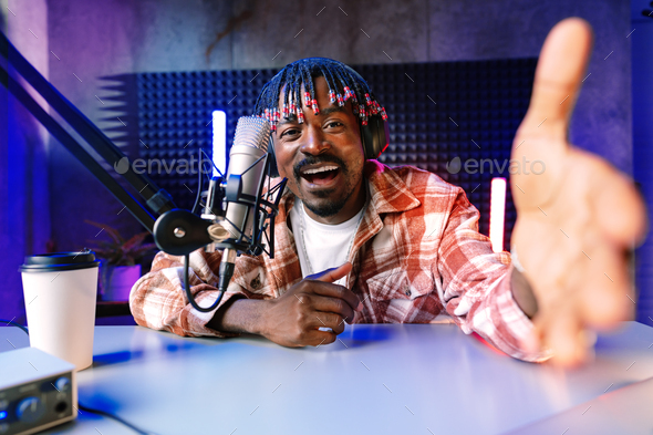 Happy young african man audio blogger broadcasting at studio - Stock Photo - Images