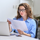 Young business woman manager holding documents working in office with laptop. - PhotoDune Item for Sale