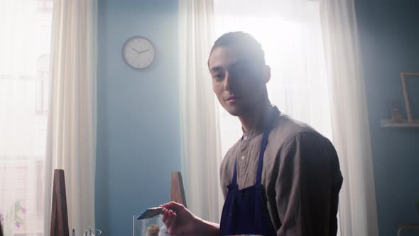 Portrait of Young Man Artist Looking at Camera alt