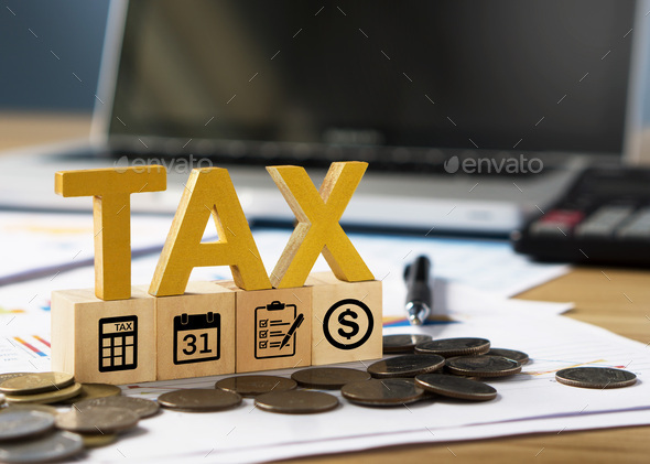 Tax wooden letter and tax icon on wooden block.Pay tax in new year. - Stock Photo - Images