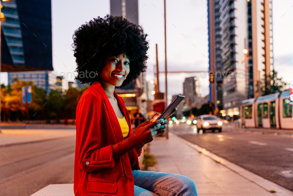 Beautiful young black woman outdoors in the city - Stock Photo - Images