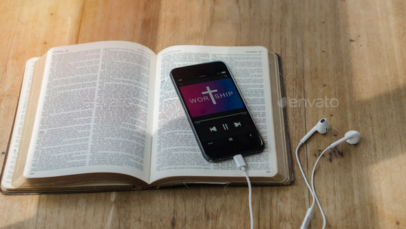 open bible with phone and headphones,Concept listen the words of God.