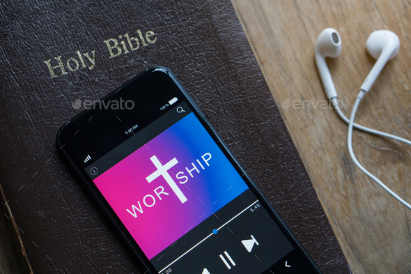Bible with phone and headphones,Concept listen the words of God.Bible, phone and earphones.