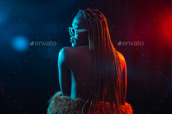 Black ethnic woman with braids with blue and red led lights, model from the back, sensual pose