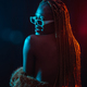 Black ethnic woman with braids with blue red led lights, model from the back, sensual pose looking - PhotoDune Item for Sale