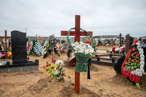 Grave crosses with wreaths in the cemetery on the sand
