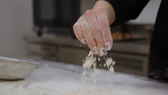 Chef Snaps His Fingers with Flour and Flour Scatters in Different Directions alt