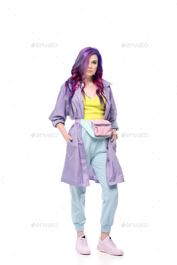 beautiful young woman in purple trench coat with waist pack isolated on white