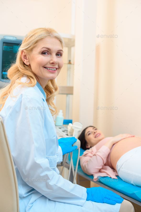 Obstetrician Gynecologist And Pregnant Woman In Ultrasound Examination ...