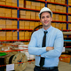 Portrait of business manager man stand in front of stack or shelves with parcel boxes in warehouse - PhotoDune Item for Sale