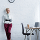 elegant senior businesswoman posing near workplace with laptop and coffee - PhotoDune Item for Sale
