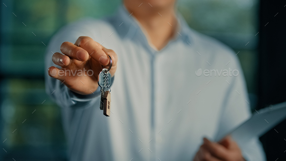 Estate agent salesman banker businessman show at camera bunch of keys from new house commercial